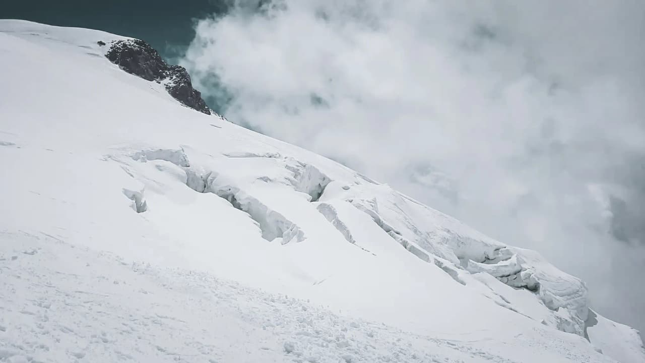 Majestic snow-capped mountains, cloudy skies, an invitation to alpine adventure.