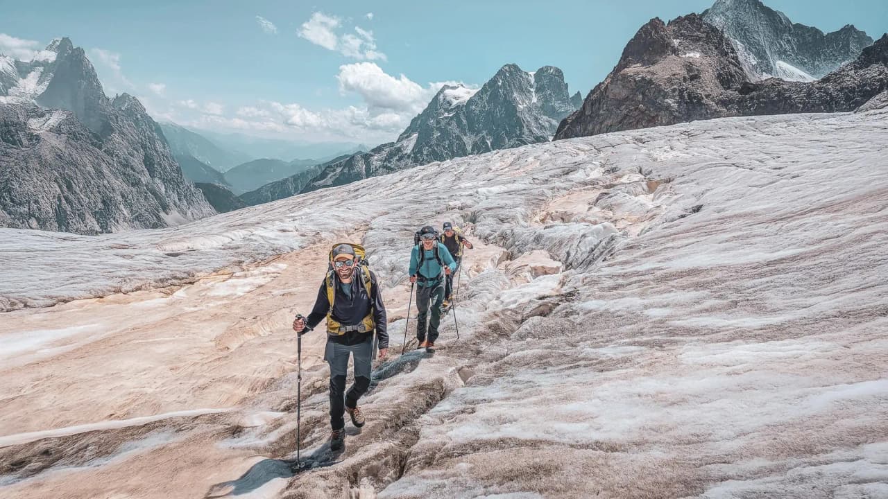 A trip to the mountains: mountaineers climb a glacier, surrounded by breathtaking scenery.