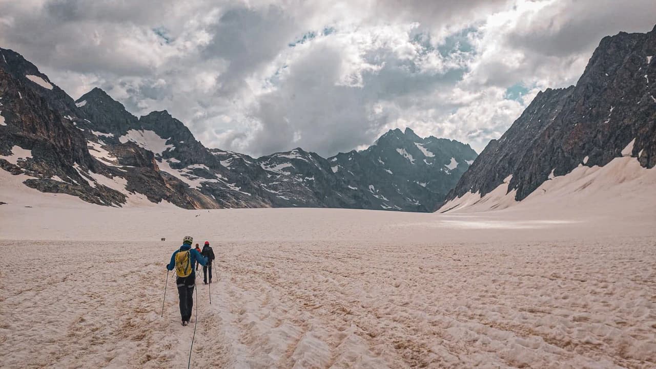 A group of climbers on a majestic glacier surrounded by mountains. Adventure guaranteed!