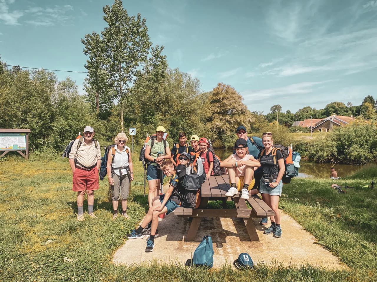 A smiling group on the banks of the Semois, ready for a packraft adventure in the heart of the Ardennes.