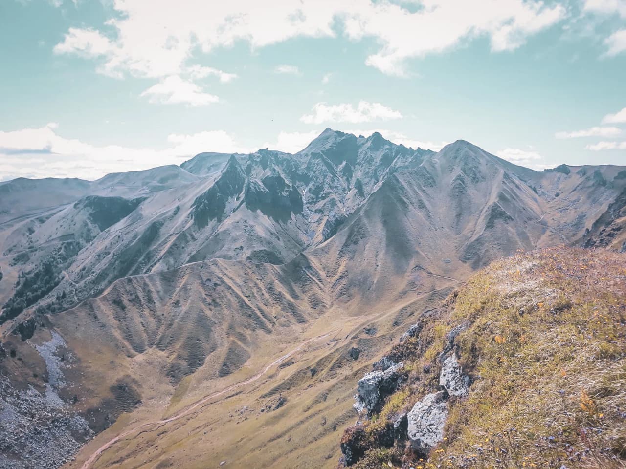 A majestic panorama of the volcanic ridges of the Massif Central, an invitation to outdoor adventure.