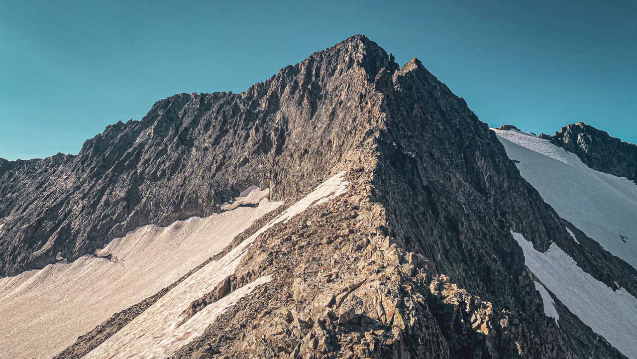 The majestic Ecrins mountains, rocky peaks and glaciers under a blue sky. Alpine adventure guaranteed!