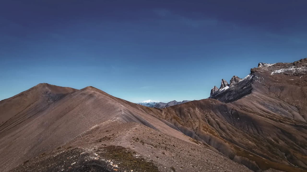 Majestic panoramic views of the arid peaks and valleys of the mountain plateau, with brilliant blue skies.