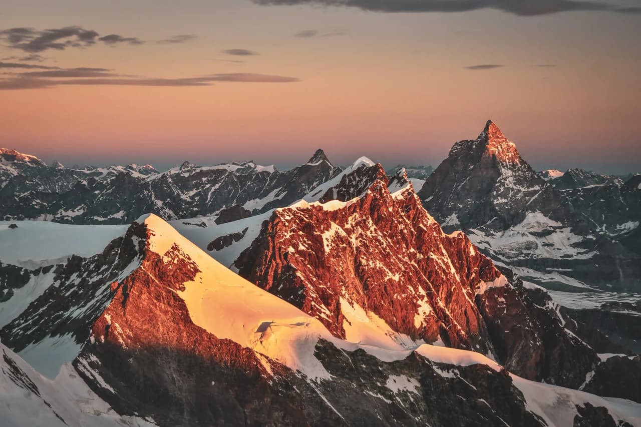Magical sunsets over the snow-capped peaks of Mont Rose, an invitation to alpine adventure.