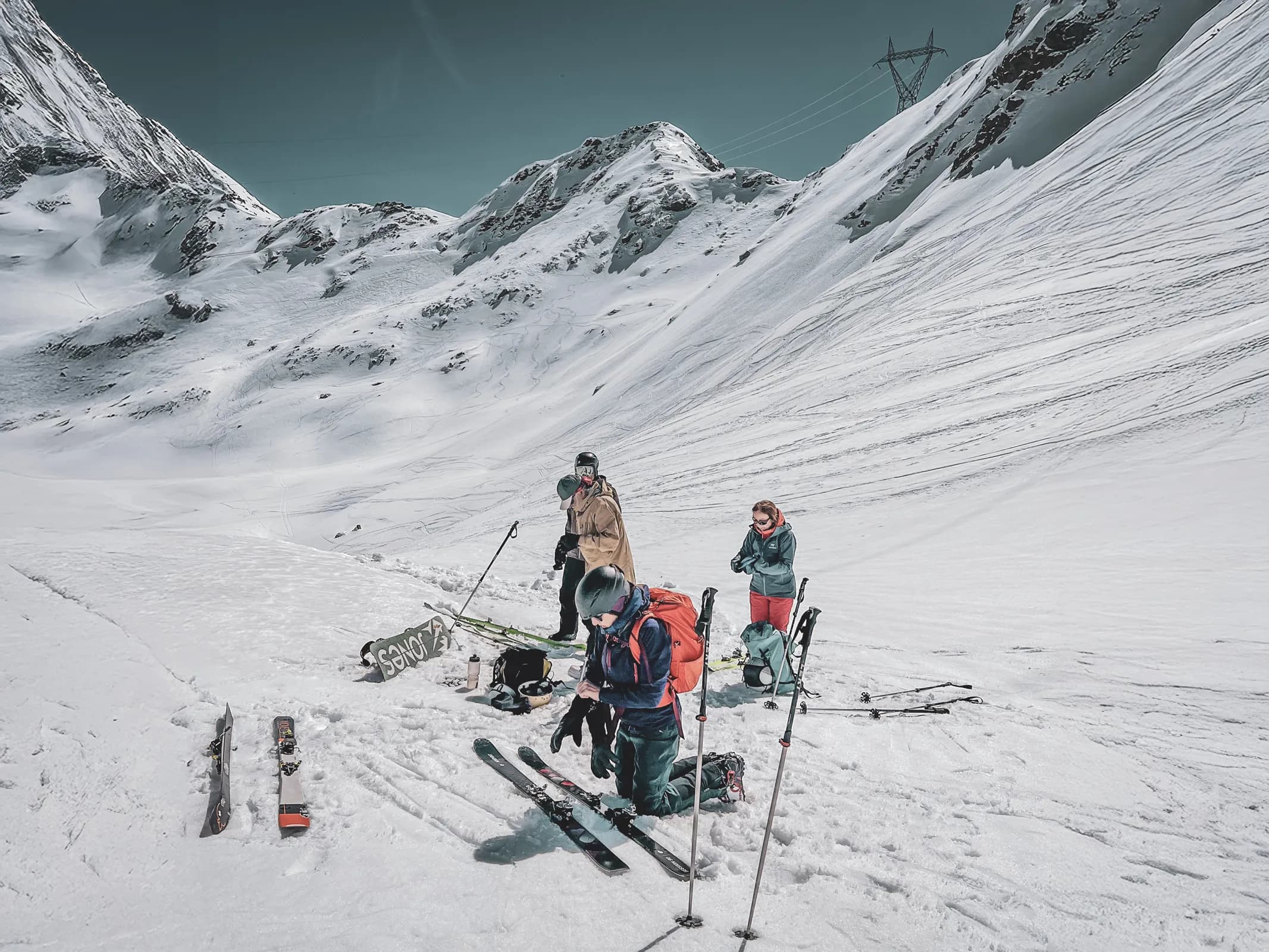 A group of skiers preparing for an adventure in a spectacular snow-covered alpine landscape.