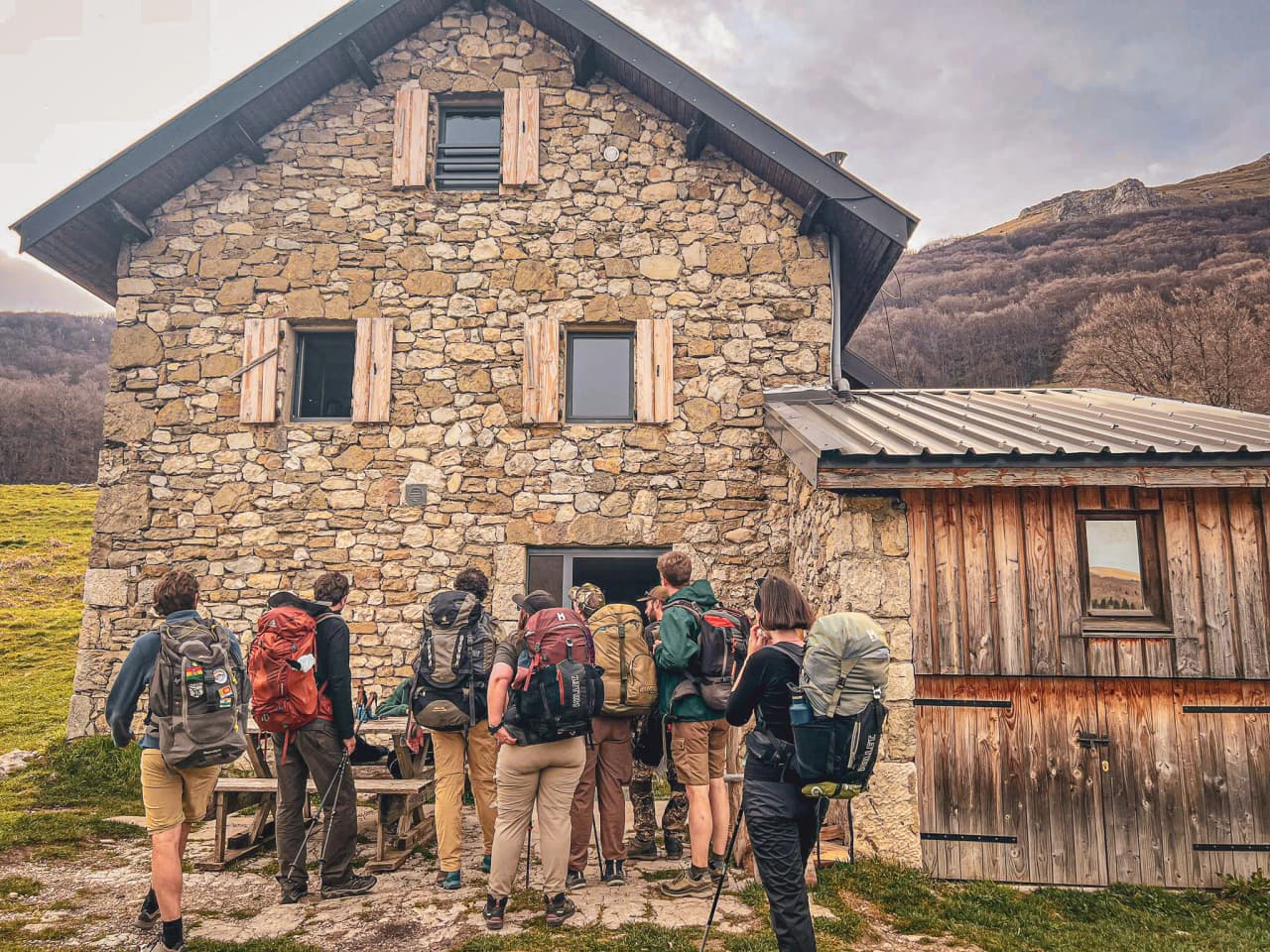 Groupe de randonneurs devant une maison en pirre