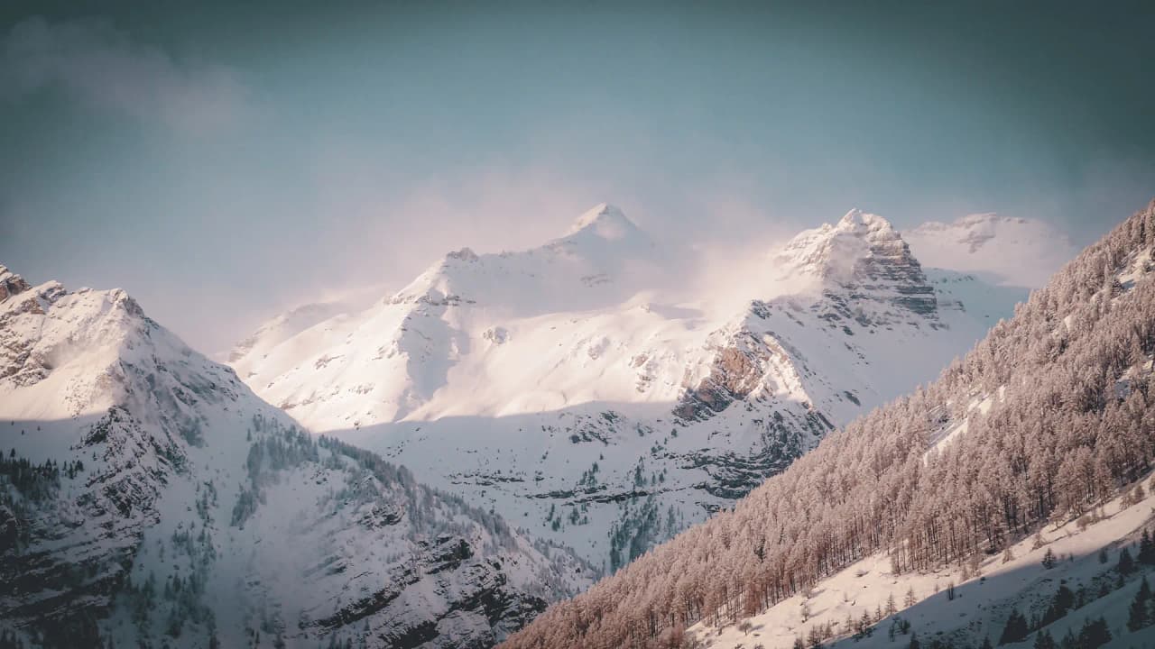 Snow-capped mountains under clear skies, an invitation to alpine adventure in the Clarée valley.
