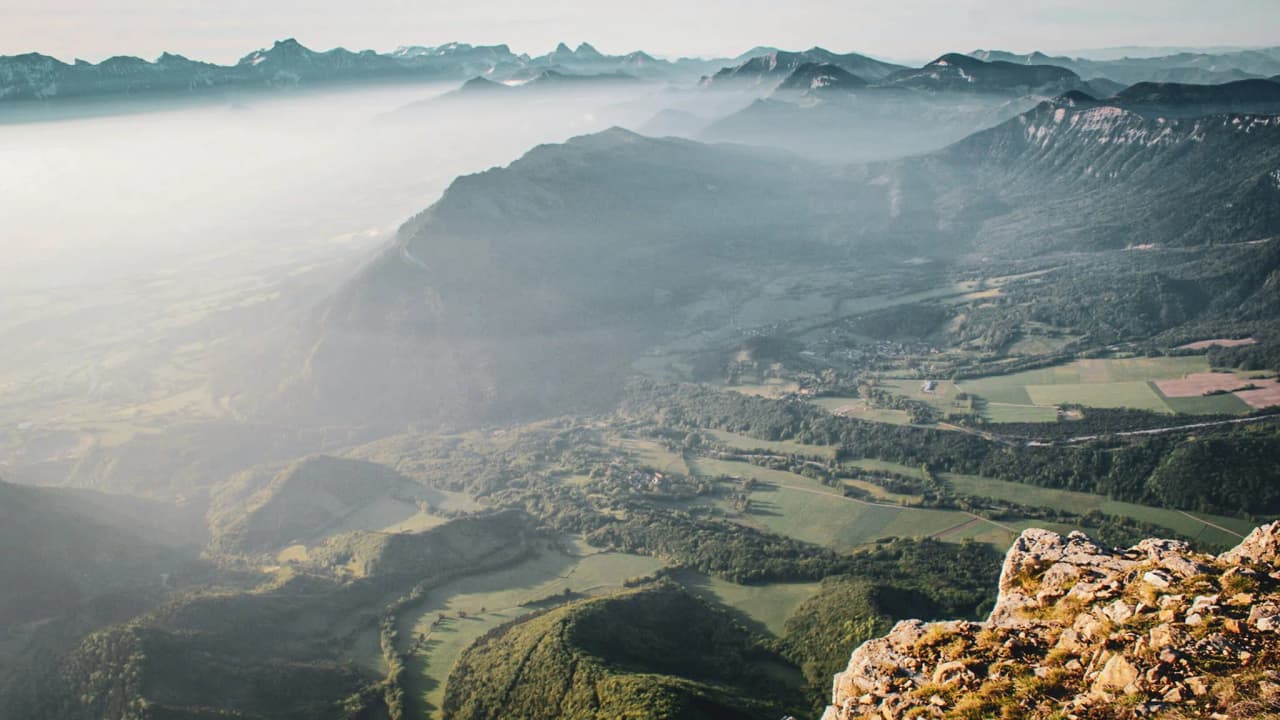 Spectacular views from Mont Aiguille, with misty mountains and green valleys.