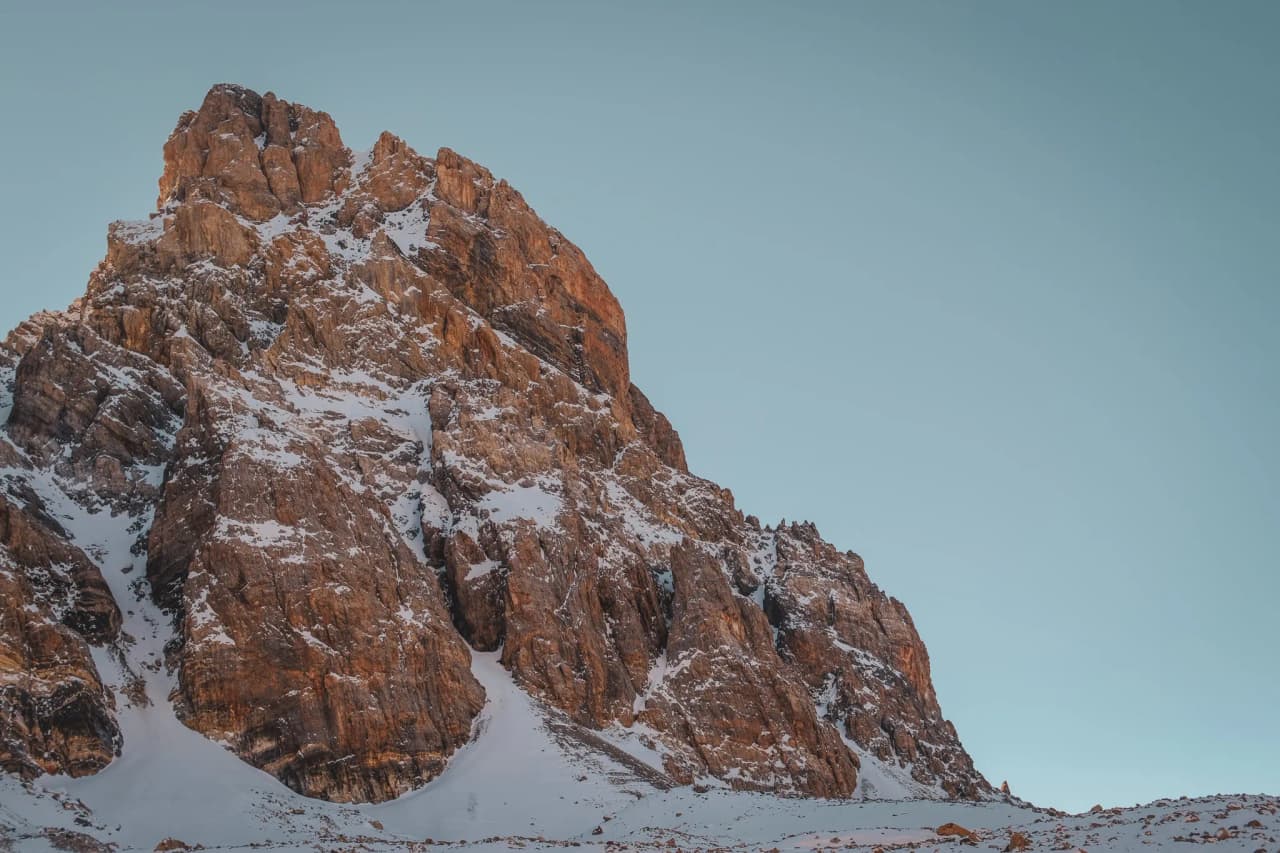 A magnificent rocky peak covered in snow, offering breathtaking views of the Alps.