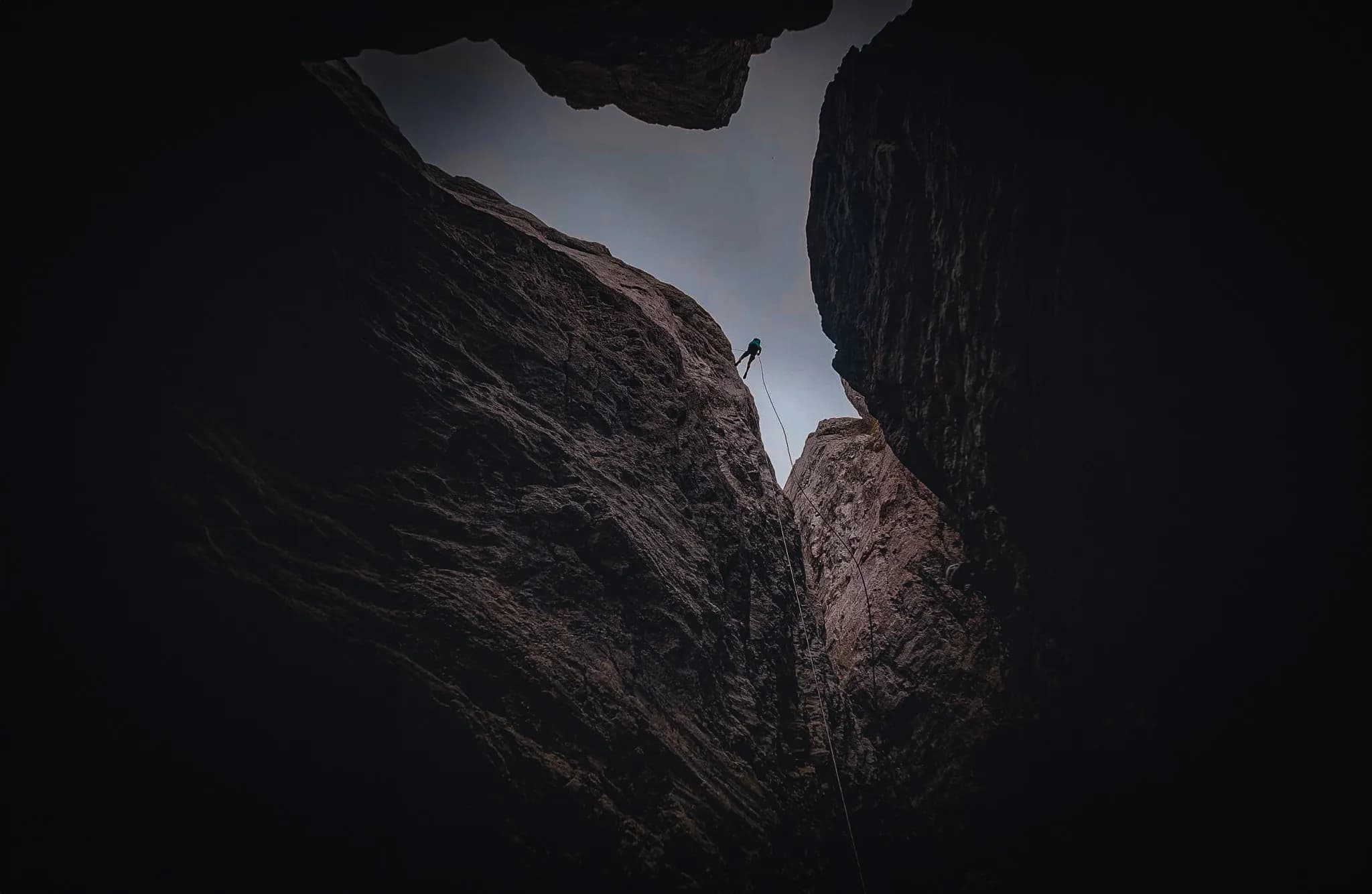 A daring climb between two rock faces, against a backdrop of sky, towards Mont Aiguille.