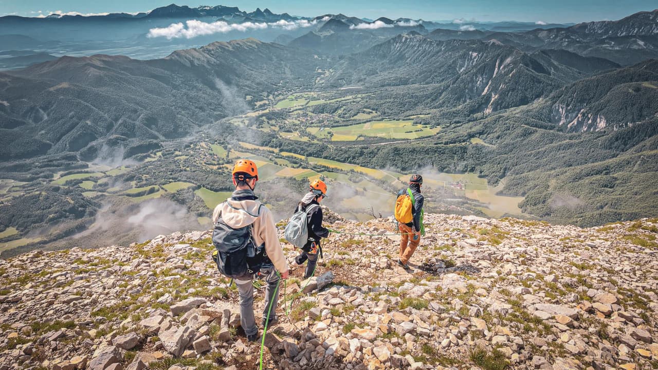 A climbing group at Mont Aiguille, taking in the stunning, lush, mountainous scenery.