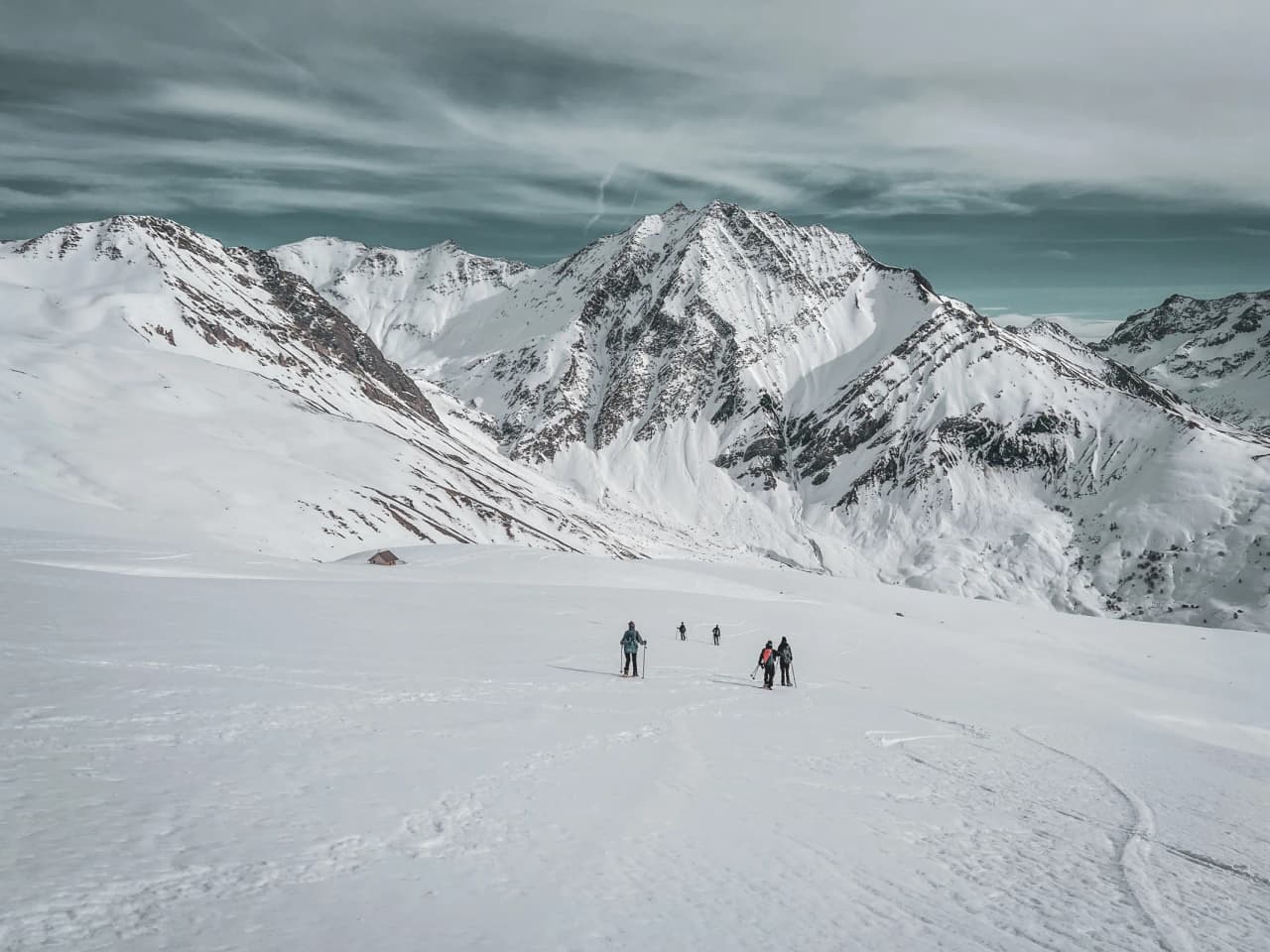 Hikers skiing down one of the Meije glaciers