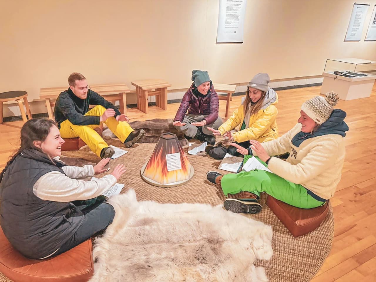 A group of travellers share warm moments around a fire in Swedish Lapland.