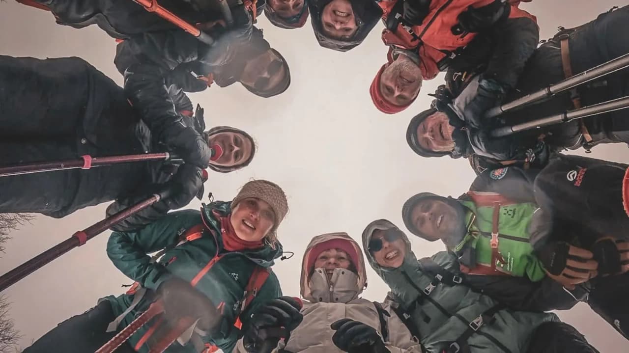 A happy group snowshoeing under the winter skies of the Vosges, ready for adventure.