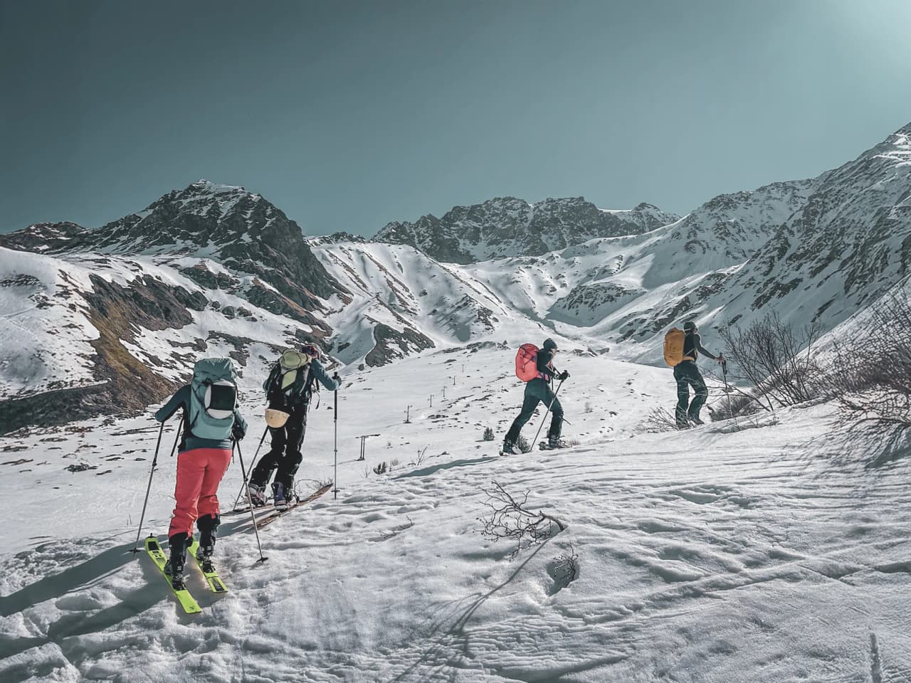 A group of adventurers on ski touring through snow-covered Alpine landscapes on the Grand-Saint-Bernard.