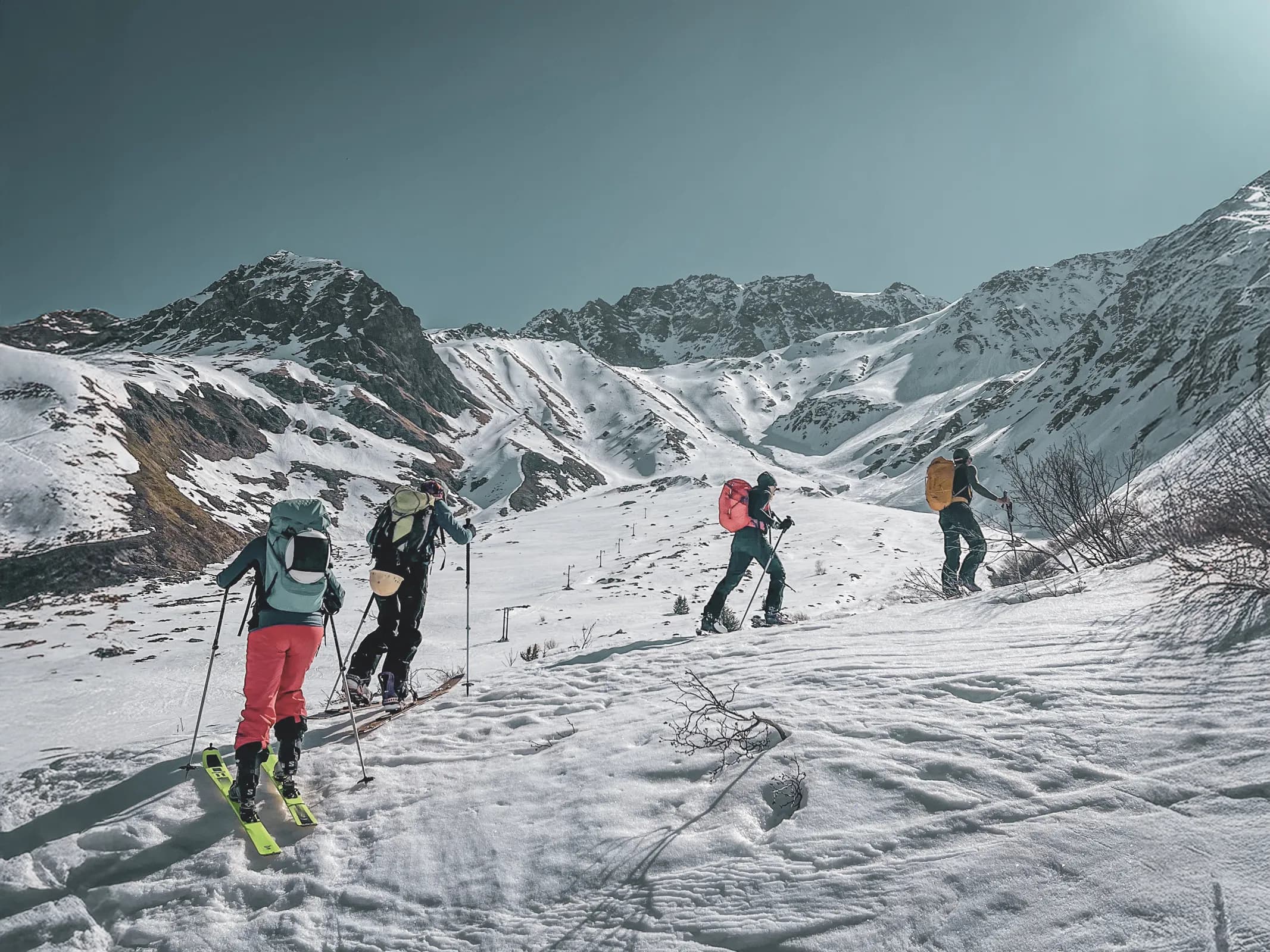 A group of adventurers on ski touring through snow-covered Alpine landscapes on the Grand-Saint-Bernard.