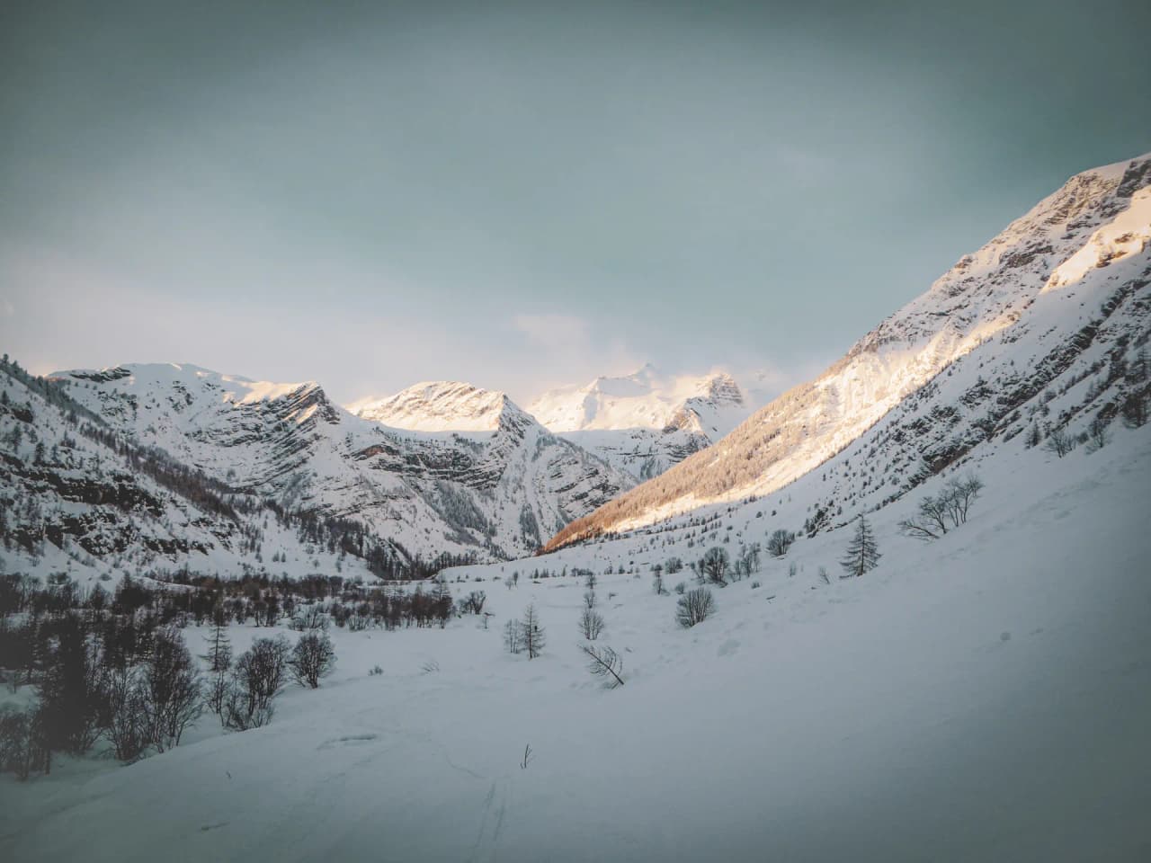 The Clarée Valley in the snow, majestic mountains lit up by the winter sun.