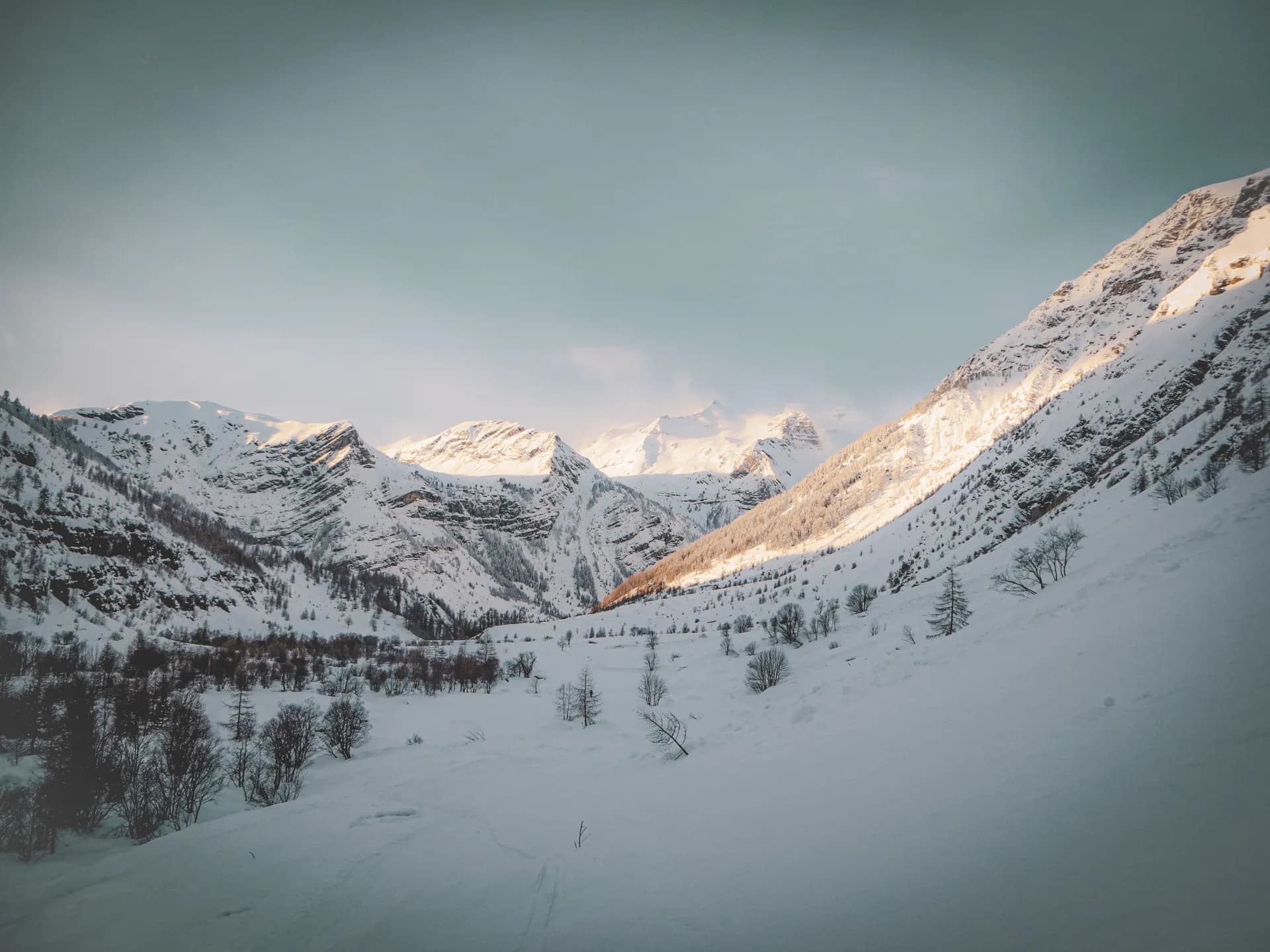 The Clarée Valley in the snow, majestic mountains lit up by the winter sun.