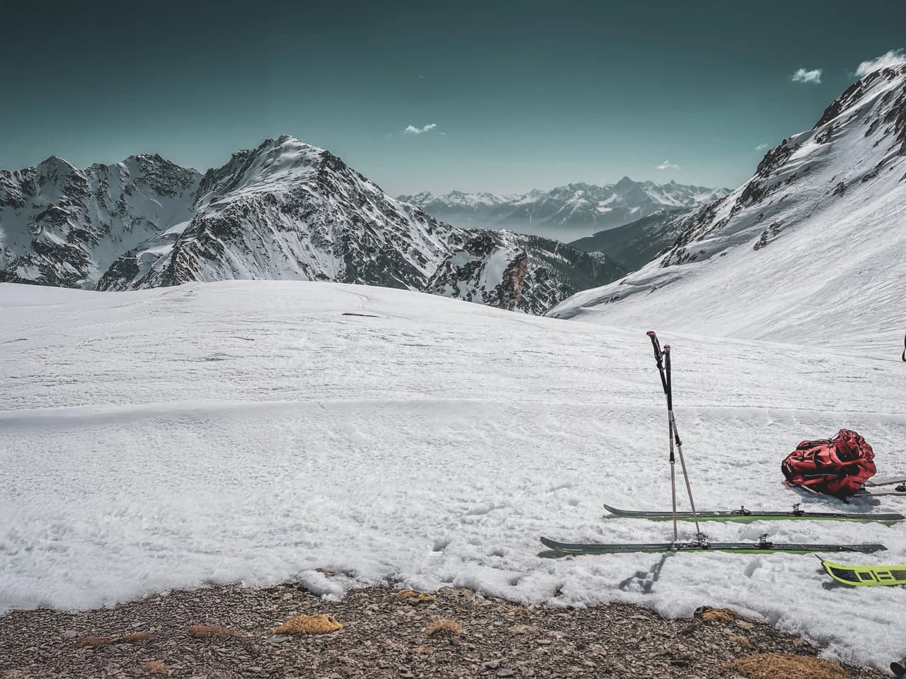 Majestic Alpine scenery with snow-capped peaks and skis on immaculate snow.