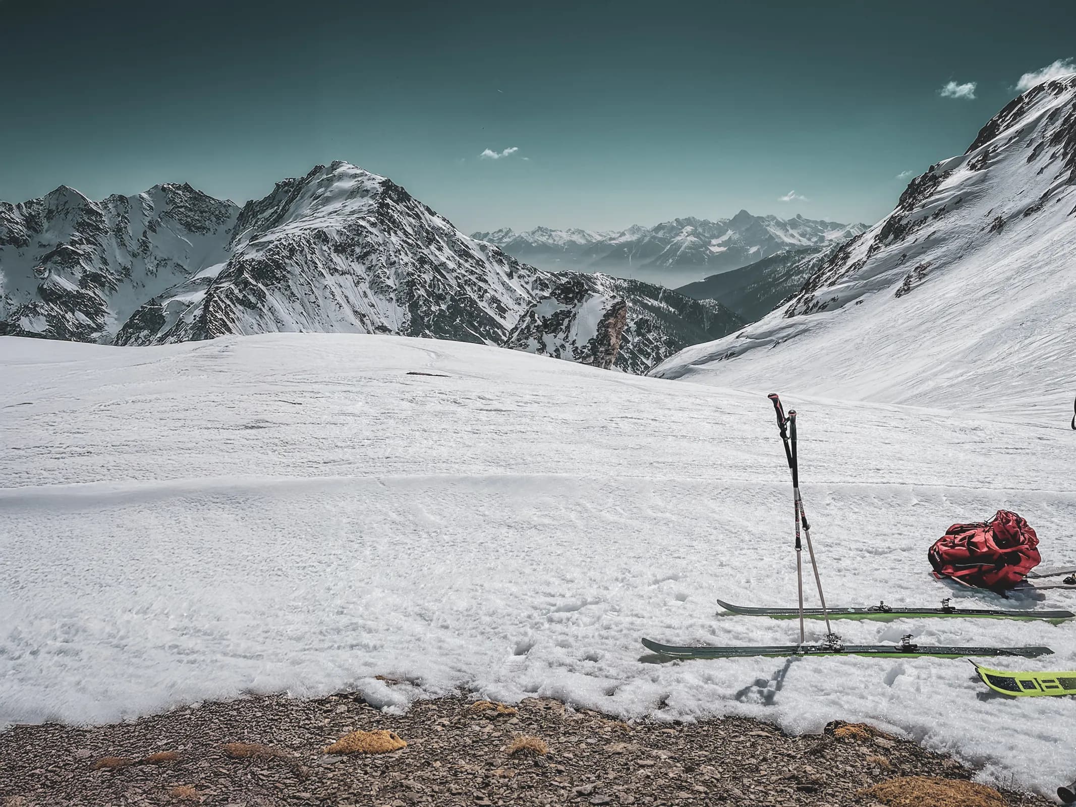 Majestic Alpine scenery with snow-capped peaks and skis on immaculate snow.