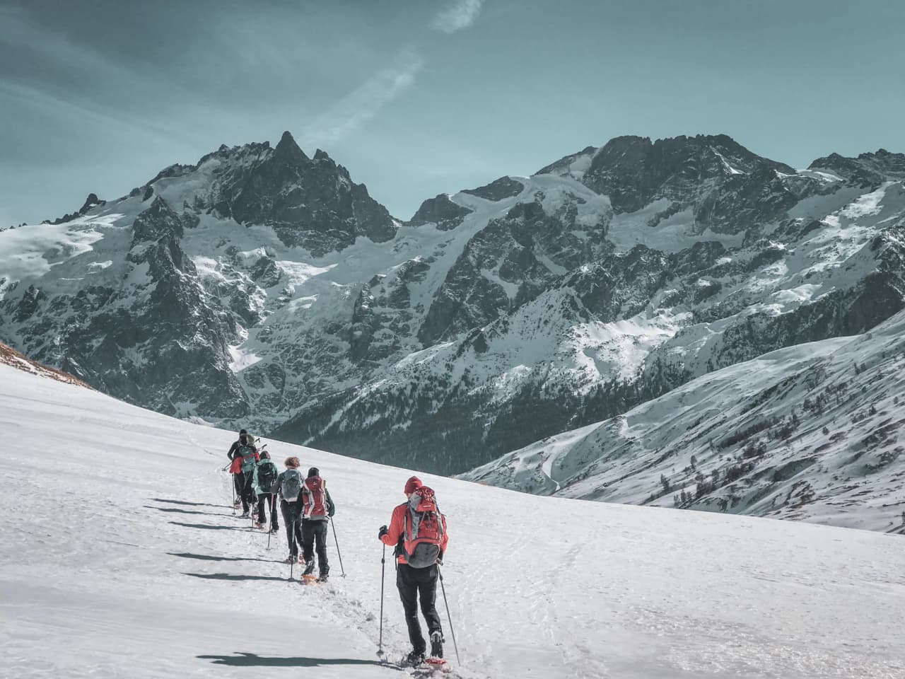 Snowshoe trekking facing the majestic glaciers of the Écrins, an enchanting panorama.