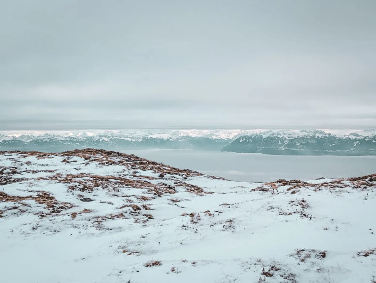 A winter panorama of the snow-capped Jura mountains, perfect for getting away from it all.